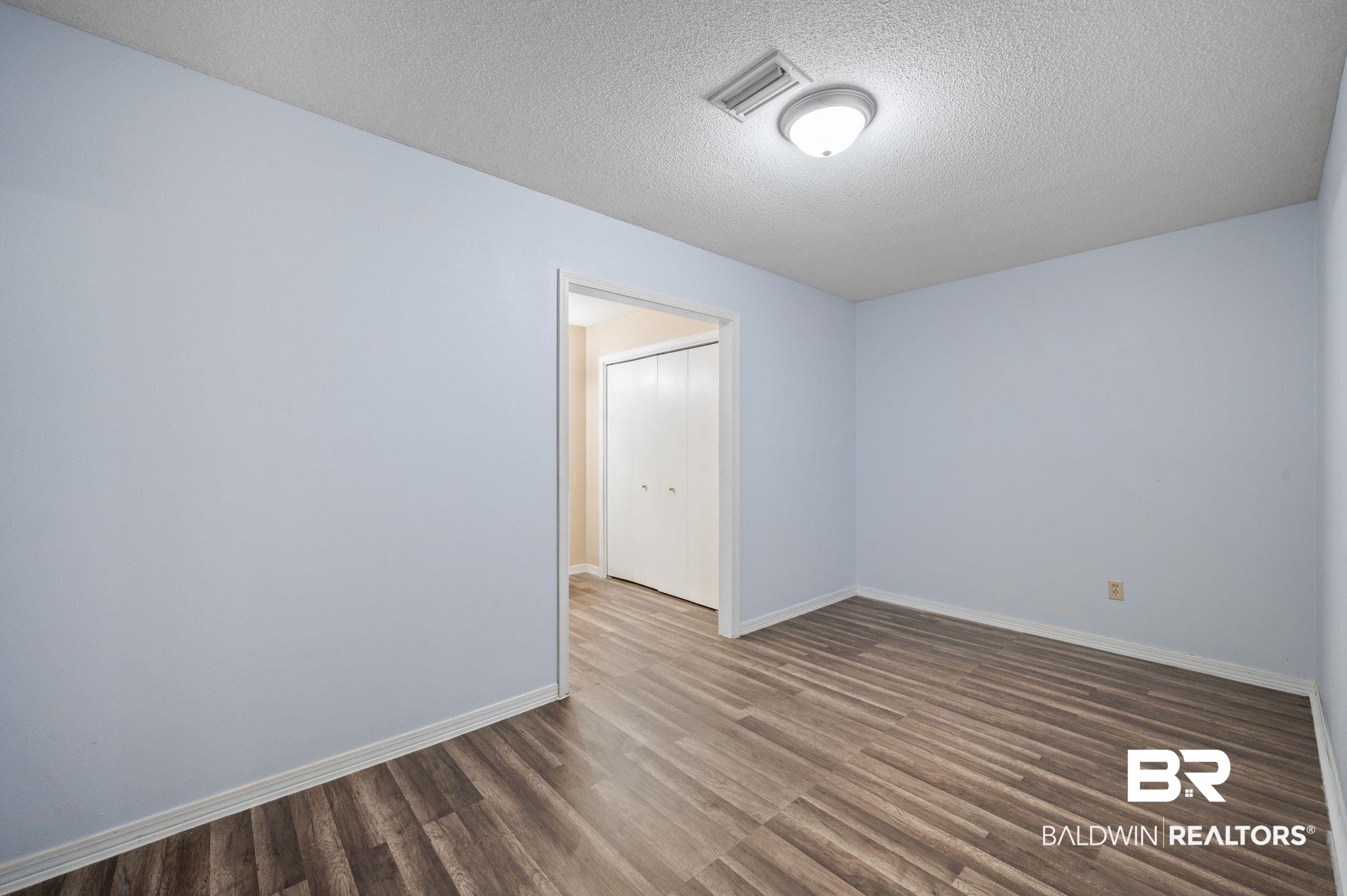 100 Orleans Way Daphne, AL 36526 - Photo 17 of 31 Empty room with a textured ceiling and dark hardwood / wood-style floors