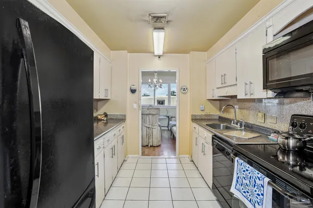 a kitchen with a sink stove and refrigerator