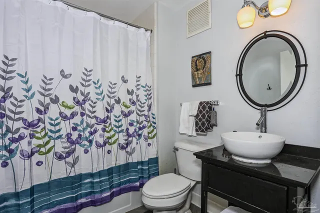 a bathroom with a toilet and a sink