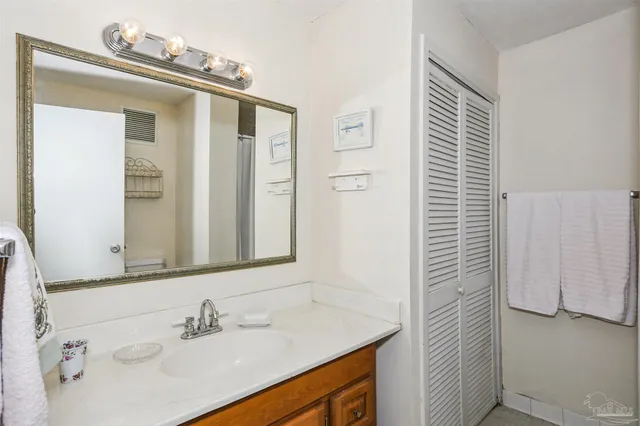 a bathroom with a sink vanity and a mirror