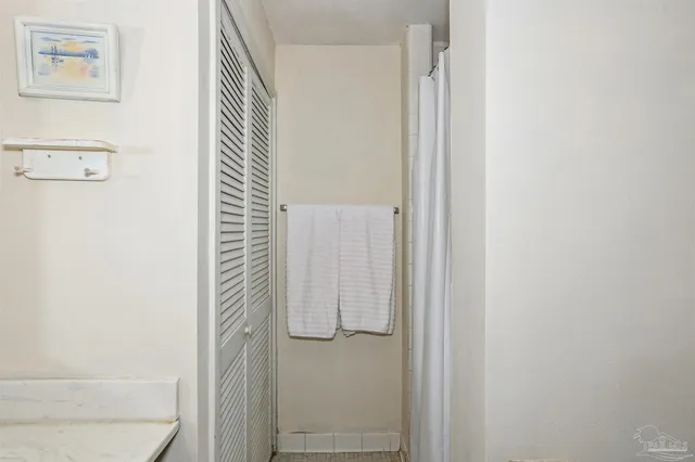 a bathroom with a shower and a door