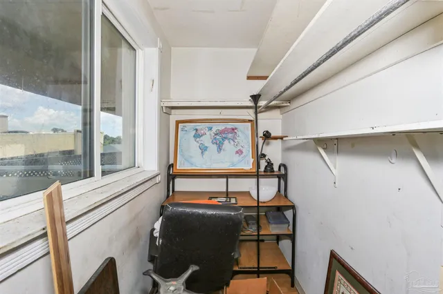 a view of a hallway with furniture and front door