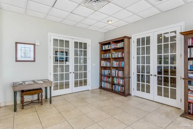 a living room with furniture a lamp and a flat screen tv
