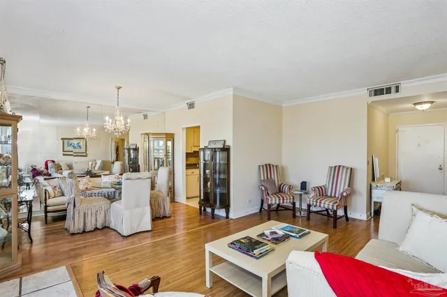 a living room with furniture and a chandelier