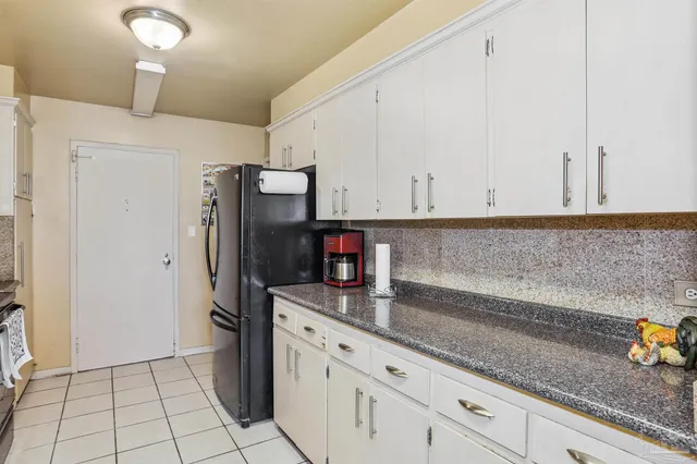 a kitchen with stainless steel appliances a refrigerator and cabinets