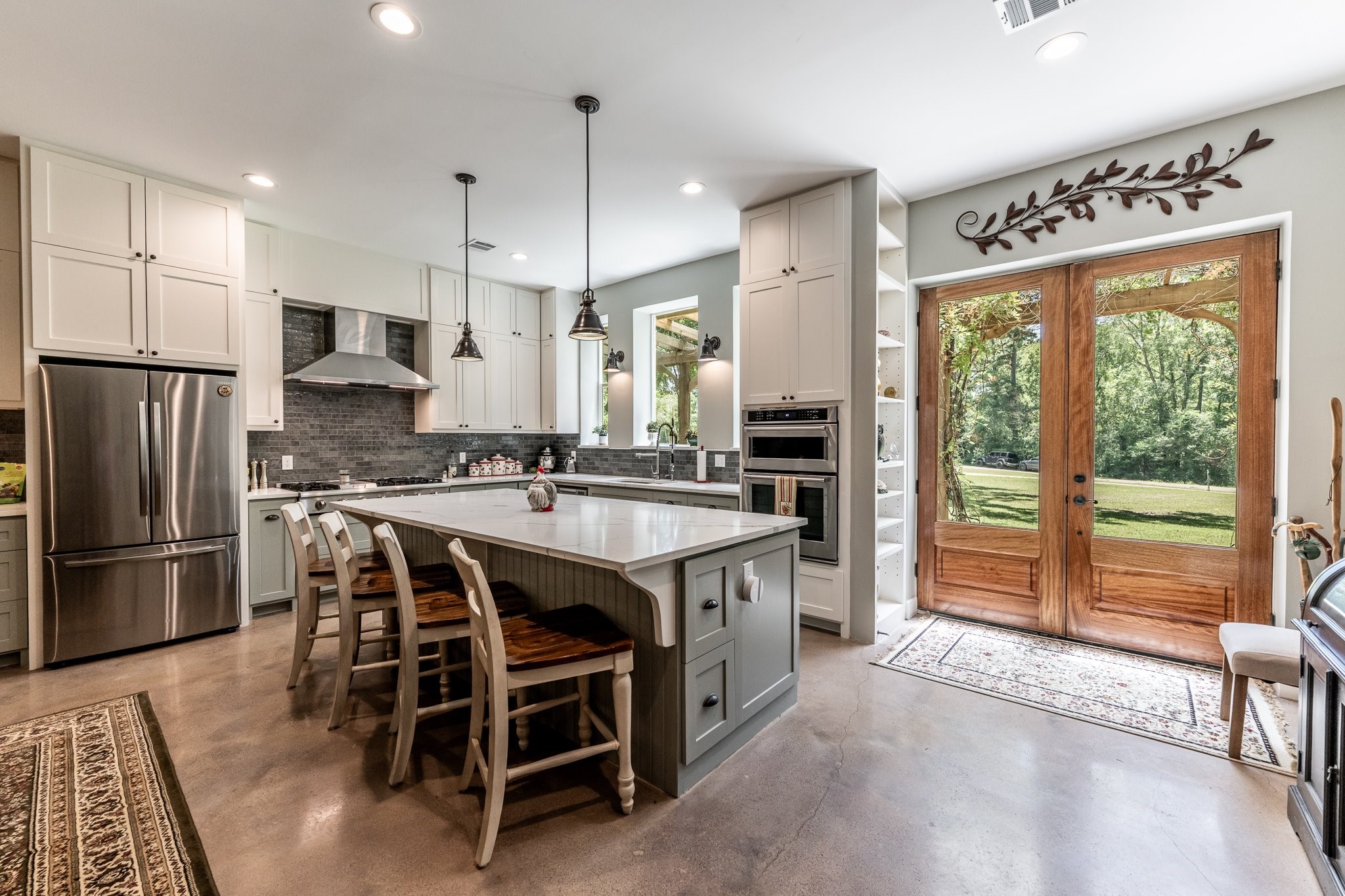 13334 Fultz Road Conroe, TX 77304 - Photo 3 of 49 a kitchen with stainless steel appliances granite countertop a stove a refrigerator a oven a sink with a dining table and chairs