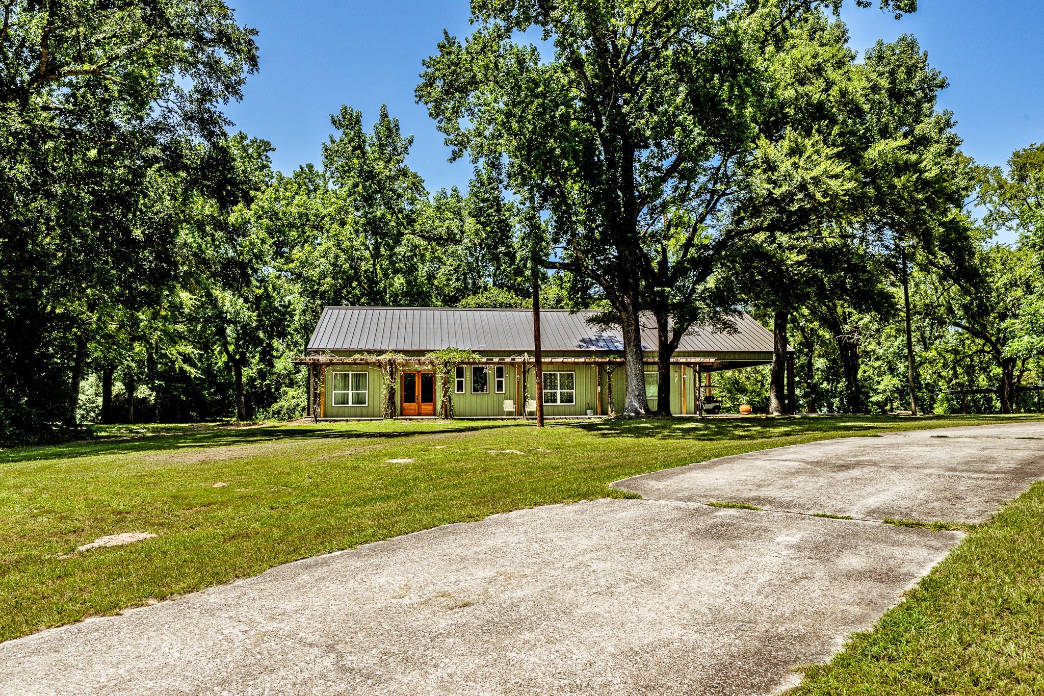 13334 Fultz Road Conroe, TX 77304 - Photo 36 of 49 a view of a big house in a big yard with large trees