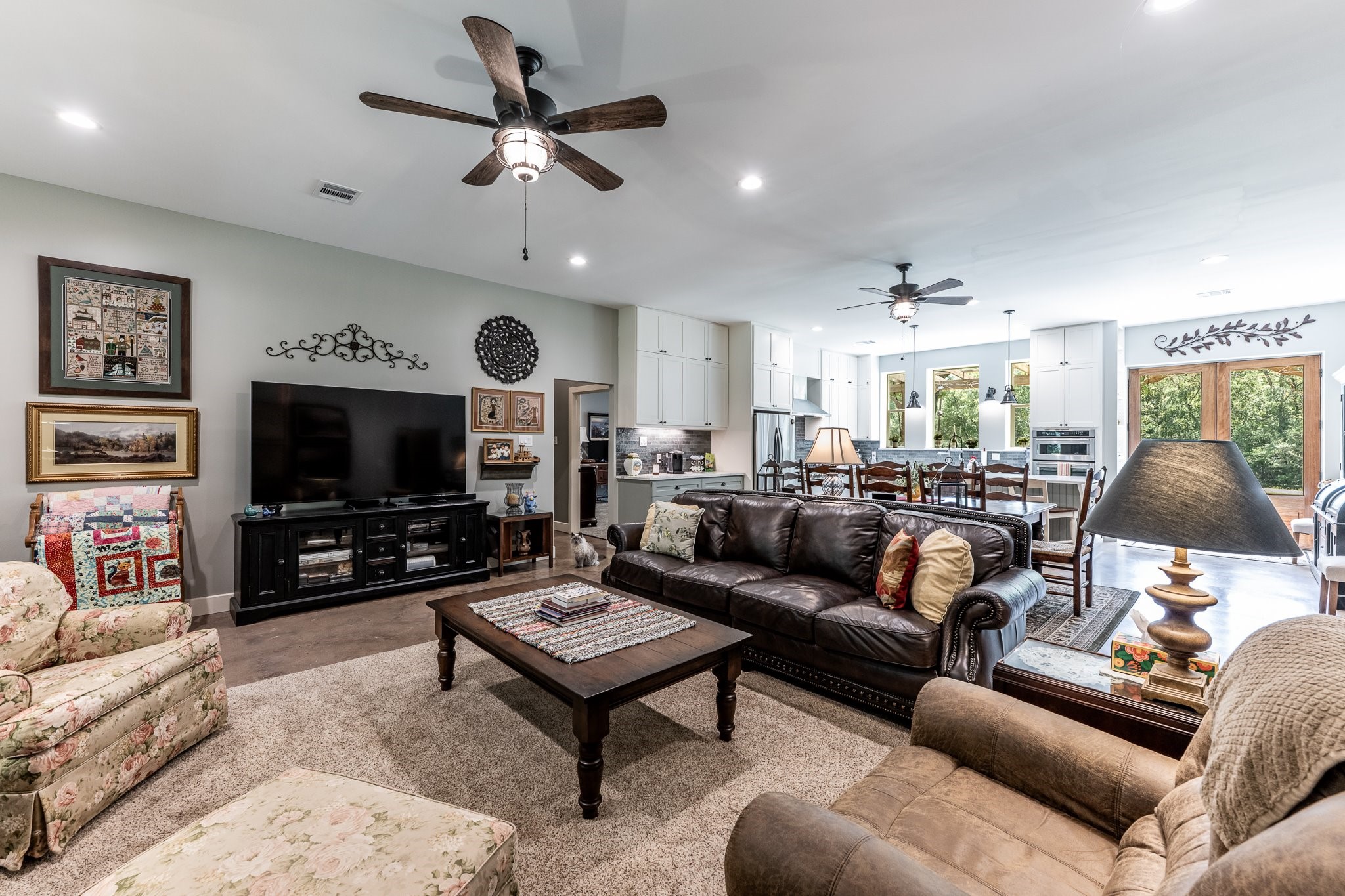 13334 Fultz Road Conroe, TX 77304 - Photo 10 of 49 a living room with furniture a flat screen tv and a fireplace