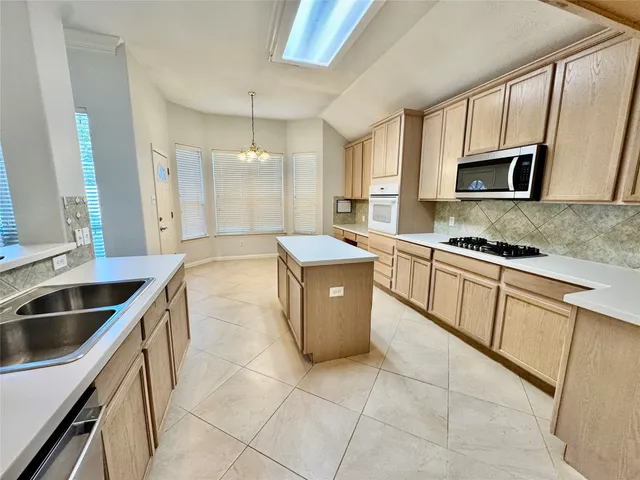 a kitchen with a sink stove and cabinets