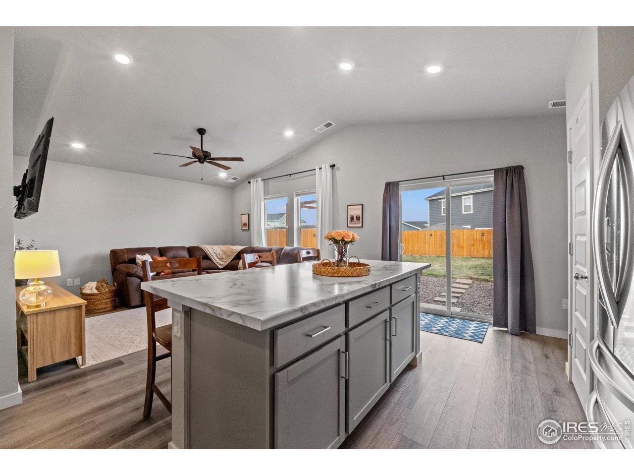 515 Wildcat Parkway Wiggins, CO 80654 - Photo 22 of 43 a kitchen with a sink a counter space and a refrigerator