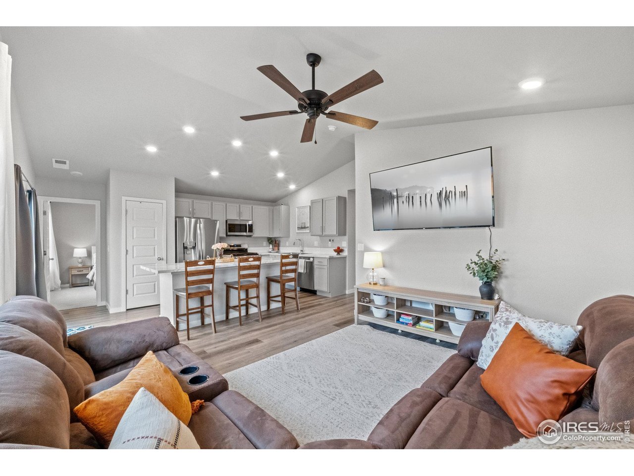 515 Wildcat Parkway Wiggins, CO 80654 - Photo 29 of 43 a living room with furniture and a wooden floor