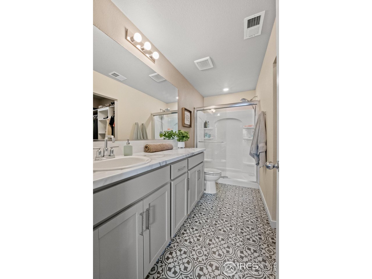 515 Wildcat Parkway Wiggins, CO 80654 - Photo 33 of 43 a bathroom with a double vanity sink mirror and a