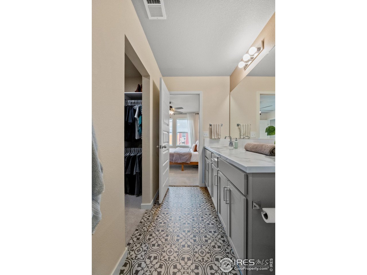 515 Wildcat Parkway Wiggins, CO 80654 - Photo 37 of 43 a en suite bathroom with a sink a mirror and a bathtub