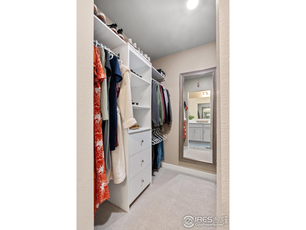 515 Wildcat Parkway Wiggins, CO 80654 - Photo 40 of 43 a view of walk in closet with clothes