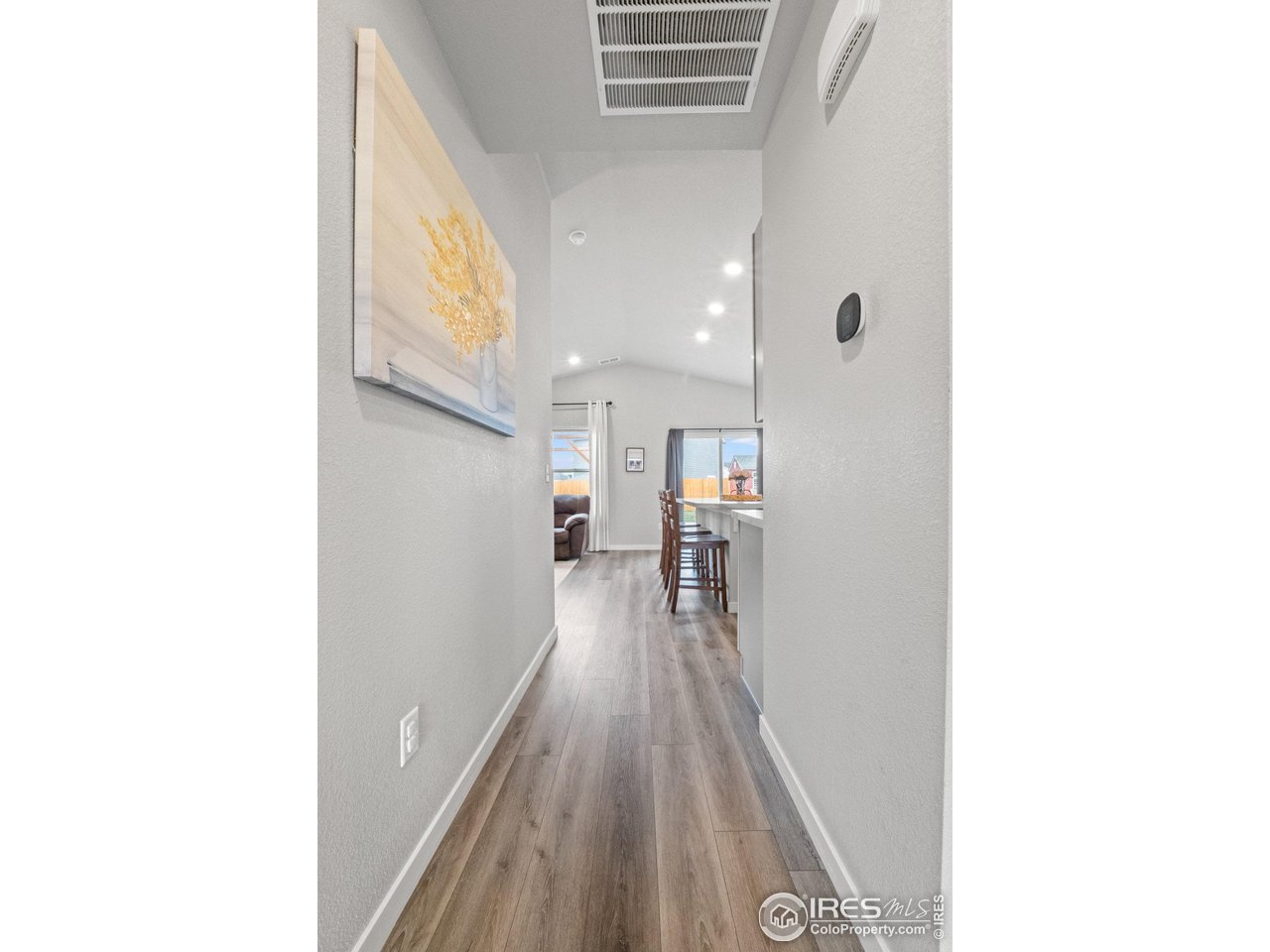 515 Wildcat Parkway Wiggins, CO 80654 - Photo 4 of 43 a view of a hallway with wooden floor