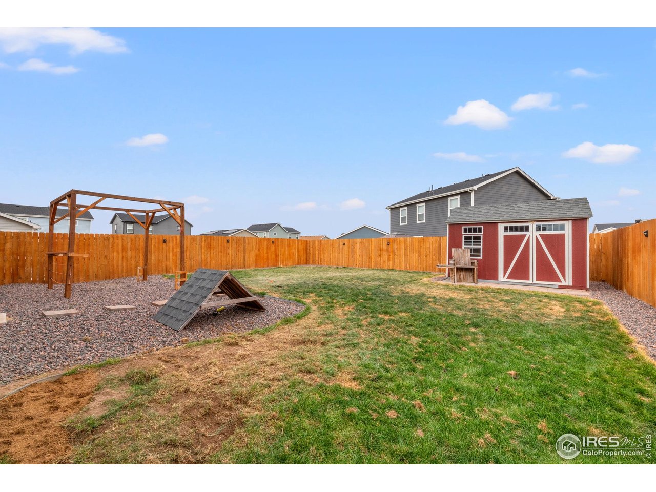515 Wildcat Parkway Wiggins, CO 80654 - Photo 42 of 43 a front view of a house with a yard