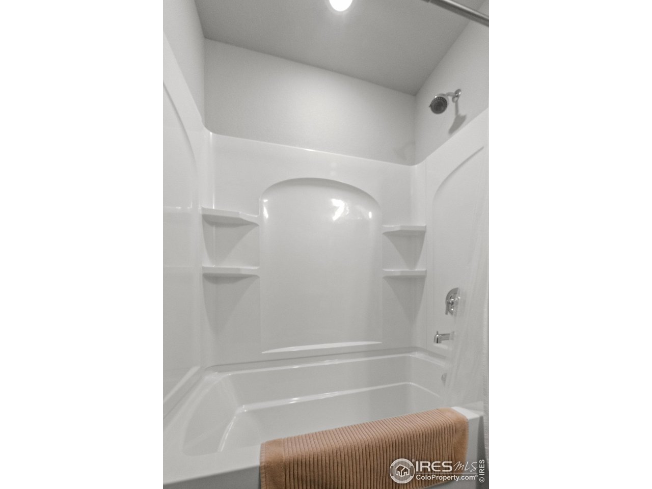 515 Wildcat Parkway Wiggins, CO 80654 - Photo 9 of 43 a bathroom with a shower