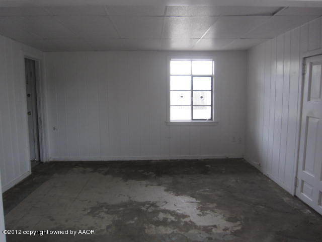 4618 Cline Road Amarillo, TX 79110 - Photo 4 of 10 an empty room with a window