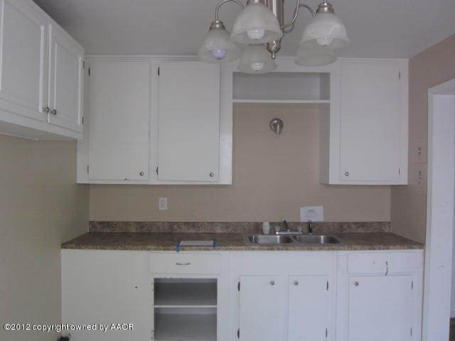 4618 Cline Road Amarillo, TX 79110 - Photo 5 of 10 a kitchen with granite countertop white cabinets and a sink