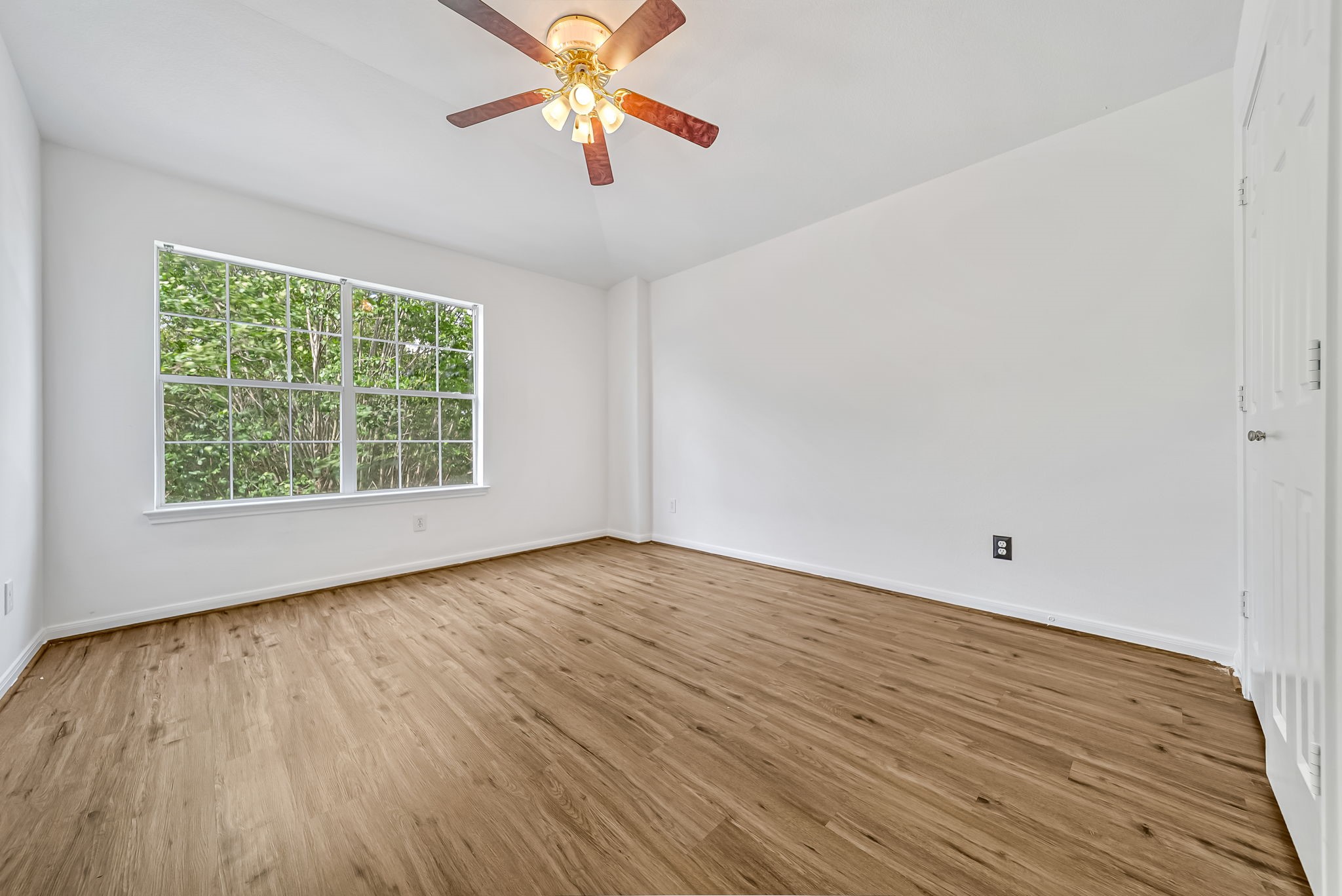 23526 Whispering Maple Drive Spring, TX 77373 - Photo 20 of 26 an empty room with windows and chandelier fan