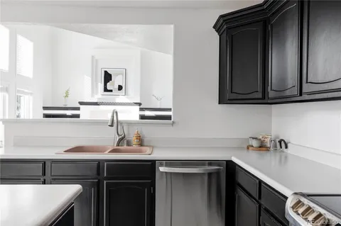a kitchen with a sink cabinets and a wooden floor