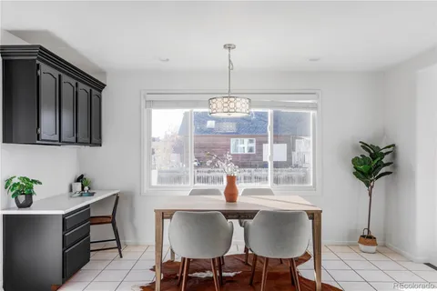 a dining room with furniture potted plants and a chandelier