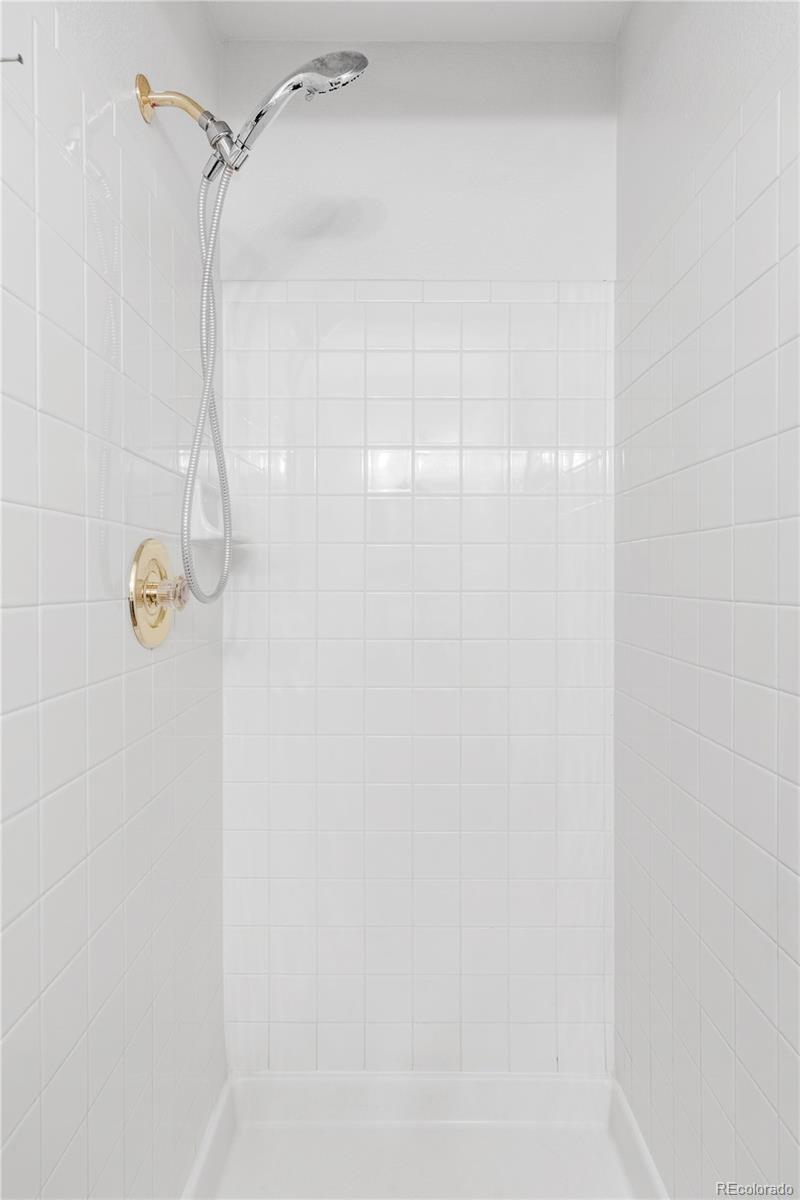 12829 Claude Place Thornton, CO 80241 - Photo 23 of 39 a bathroom with a shower