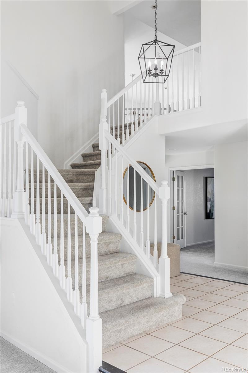 12829 Claude Place Thornton, CO 80241 - Photo 24 of 39 a view of entryway and hall with wooden floor