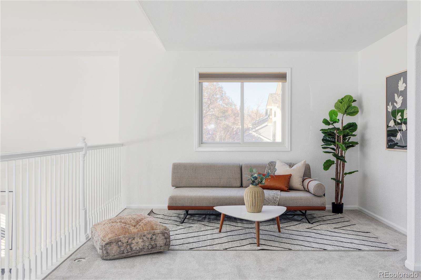 12829 Claude Place Thornton, CO 80241 - Photo 26 of 39 a living room with furniture and a window