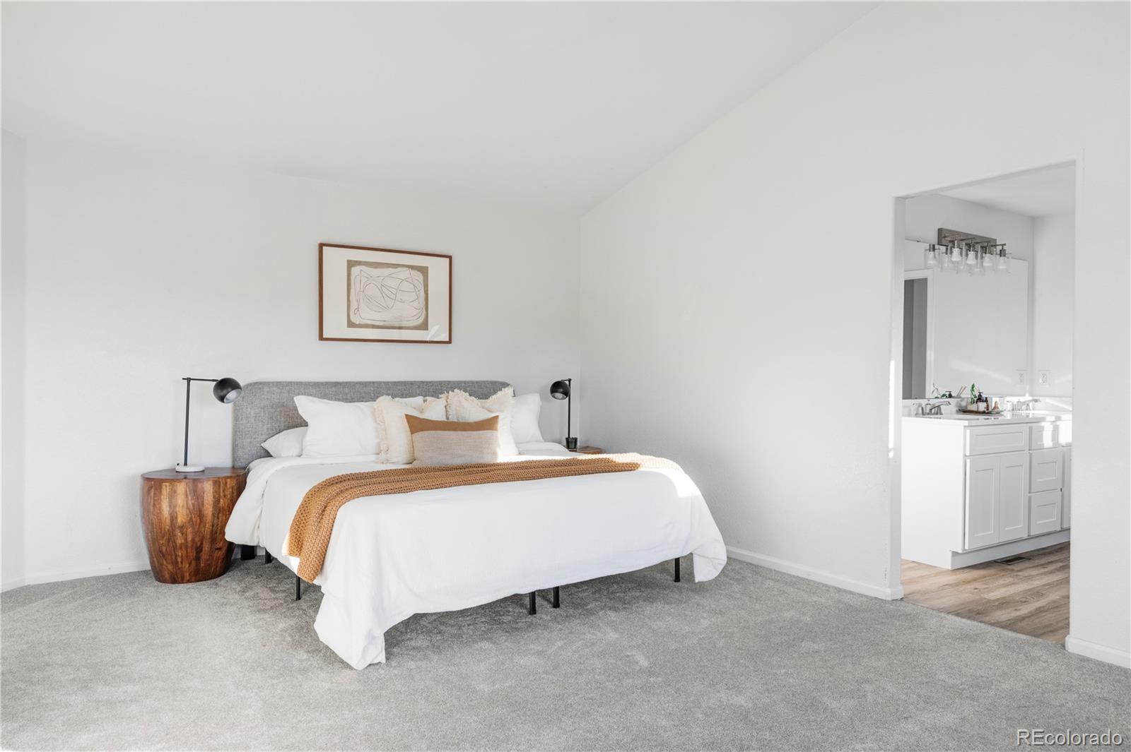 12829 Claude Place Thornton, CO 80241 - Photo 27 of 39 a bedroom with a bed and a table