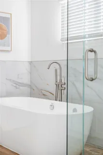 a bathroom with a bathtub and a sink