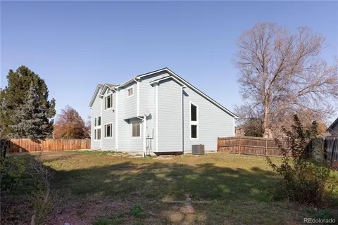 a view of a white house with a yard