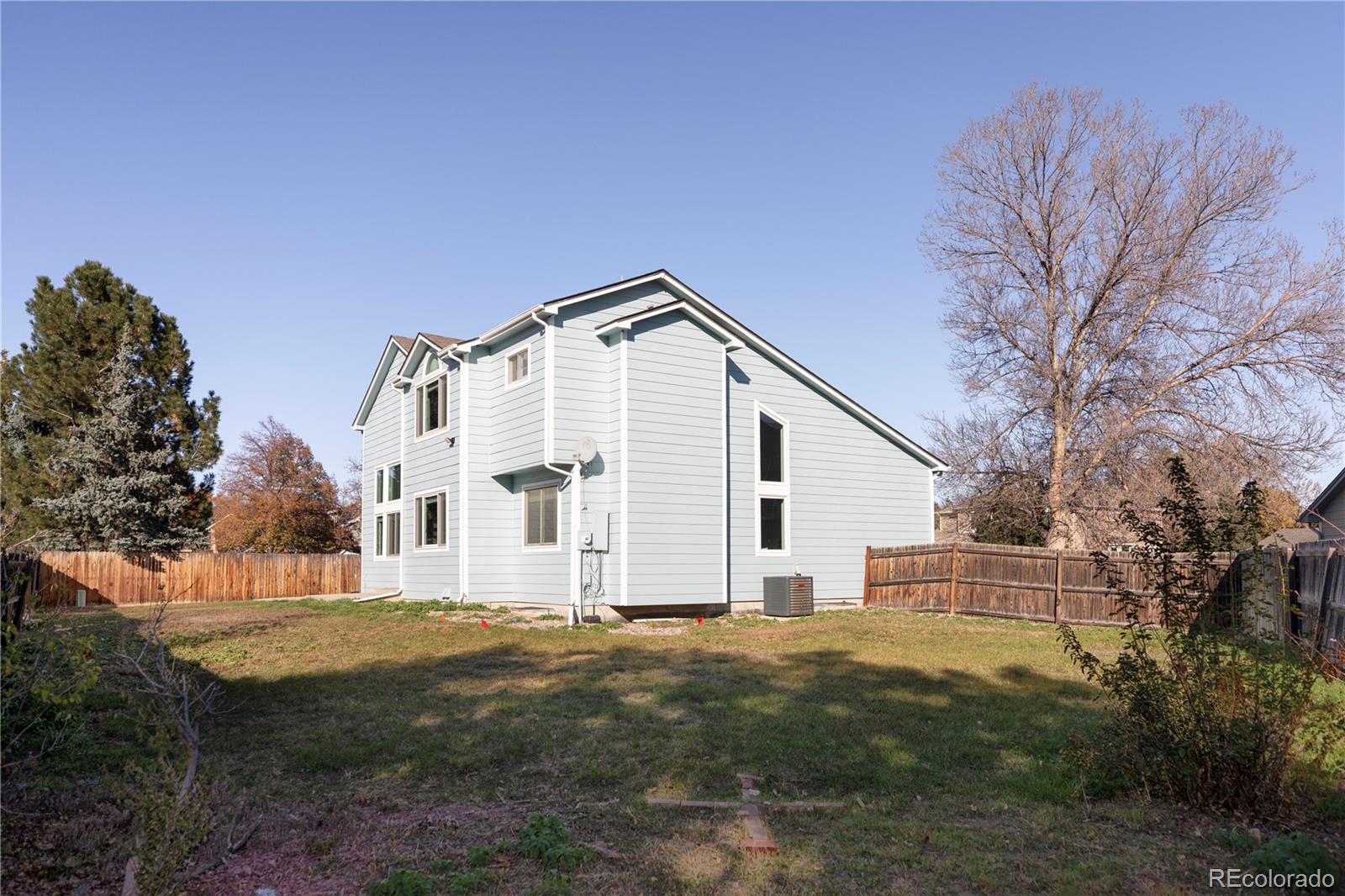 12829 Claude Place Thornton, CO 80241 - Photo 37 of 39 a view of a white house with a yard
