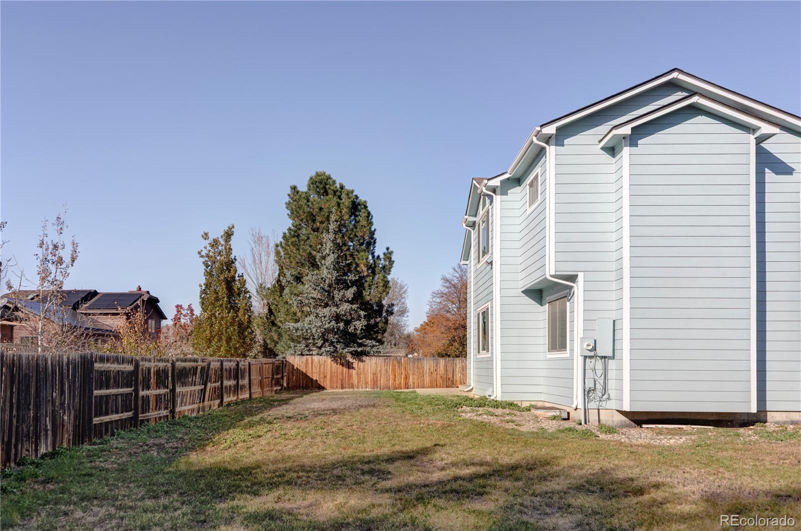 12829 Claude Place Thornton, CO 80241 - Photo 38 of 39 a view of a house with a yard
