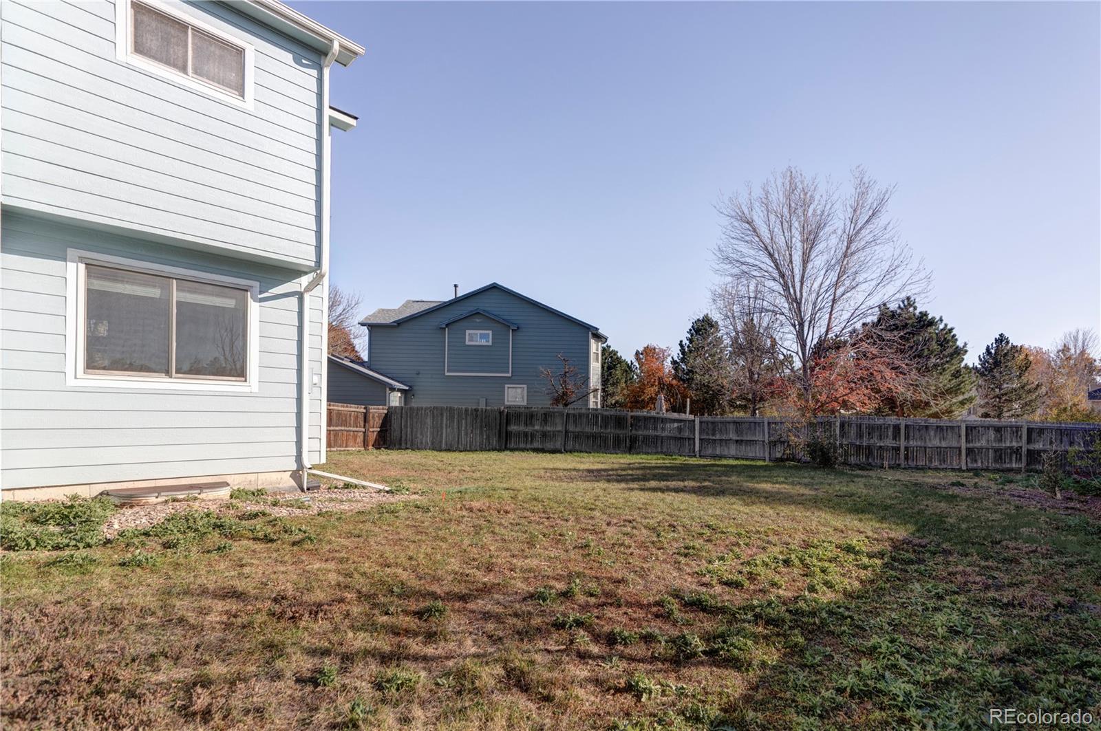 12829 Claude Place Thornton, CO 80241 - Photo 39 of 39 a view of a house with a yard