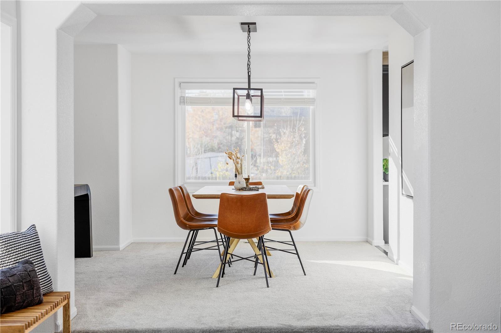 12829 Claude Place Thornton, CO 80241 - Photo 8 of 39 a dining room with furniture and wooden floor