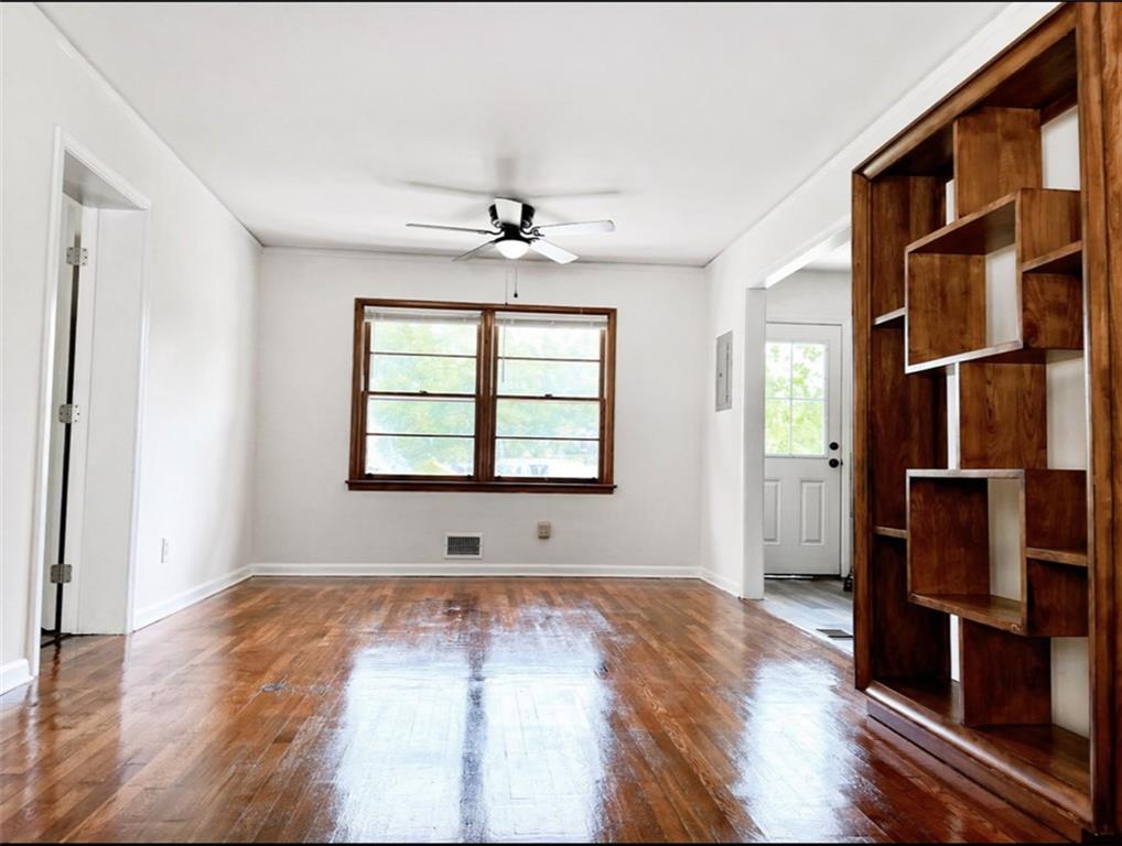 119 Fifth Avenue Jonesboro, GA 30236 - Photo 5 of 29 an empty room with wooden floor and windows
