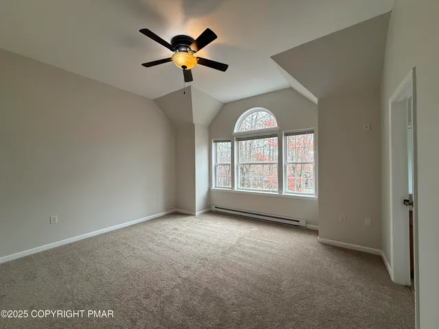 an empty room with a window and a ceiling fan