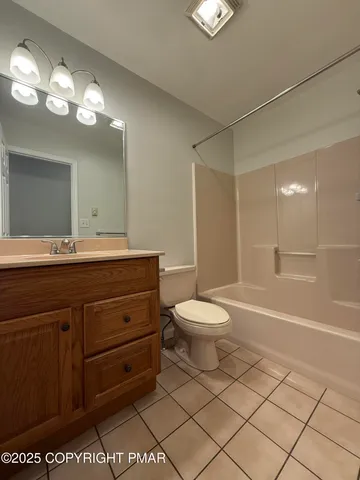 a bathroom with a sink a toilet and a large mirror