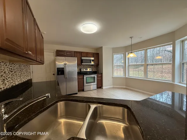 a view of a kitchen with a large window