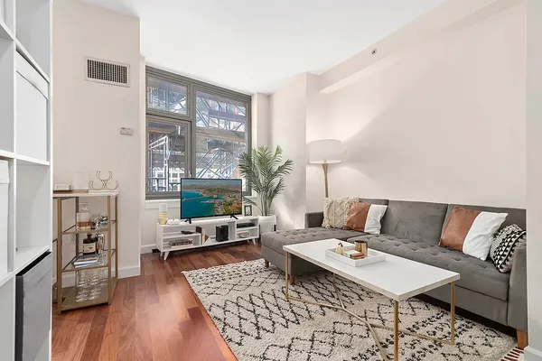 a living room with furniture and a large window
