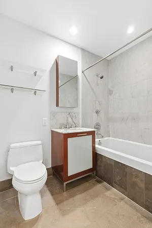 a bathroom with a toilet a sink and bathtub