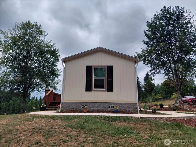a front view of house with yard and trees