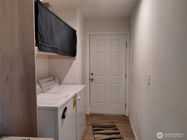 a storage room with a sink and washing machine
