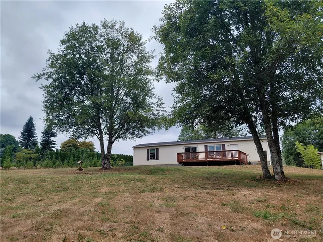 a front view of house with yard and trees
