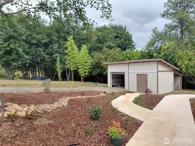 a view of a house with backyard and trees