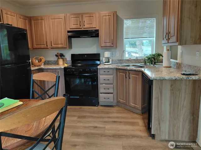 a kitchen with a stove a refrigerator and a sink