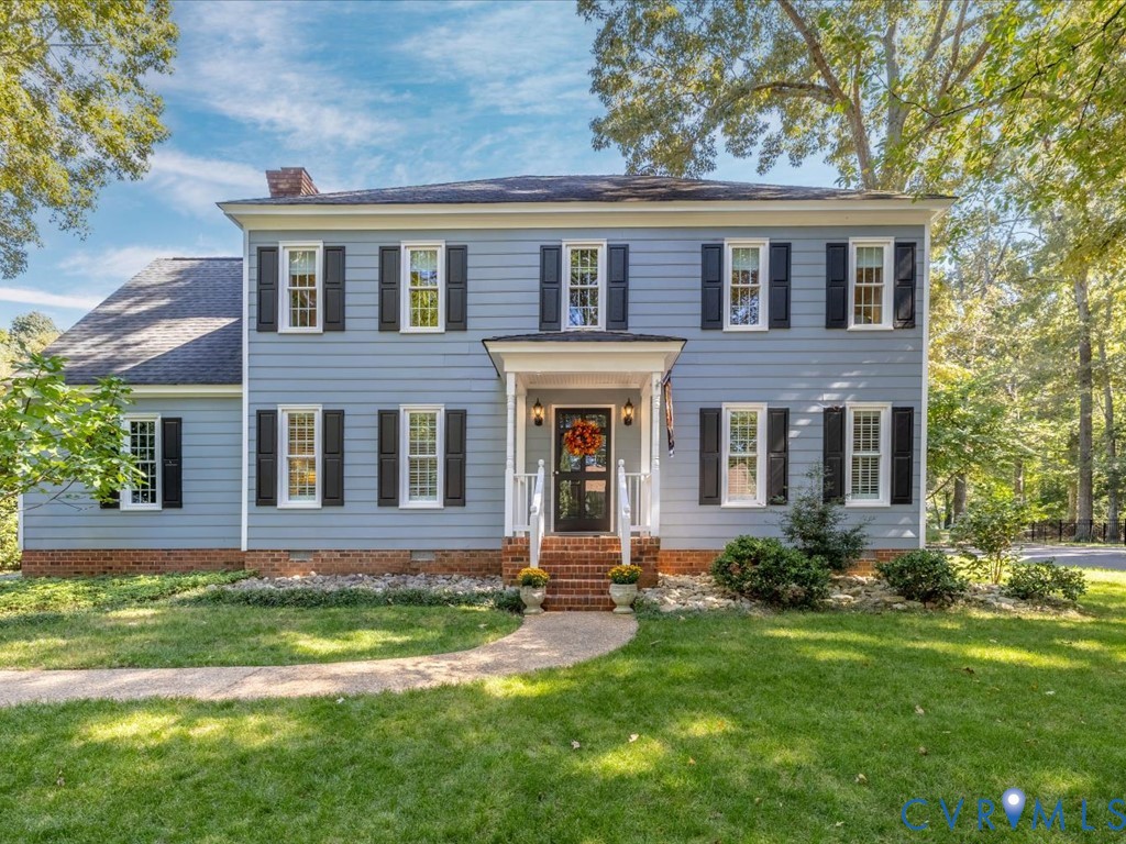 front view of brick house with a yard