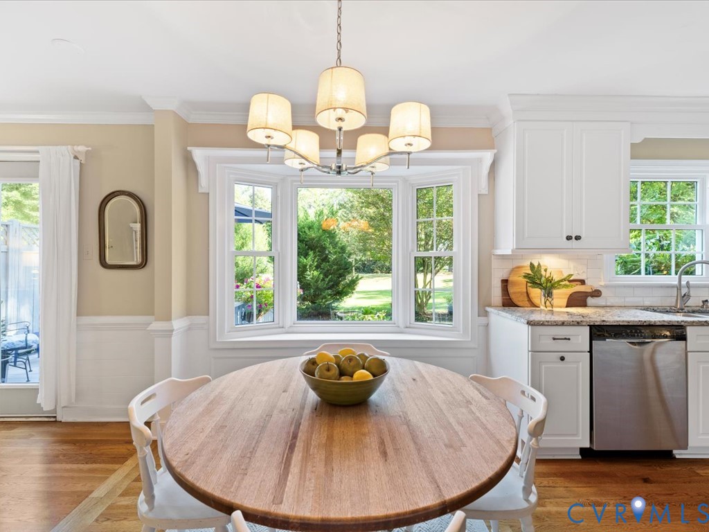 5309 Rock Harbour Road Midlothian, VA 23112 - Photo 12 of 47 a view of a dining room with furniture a chandelier and wooden floor