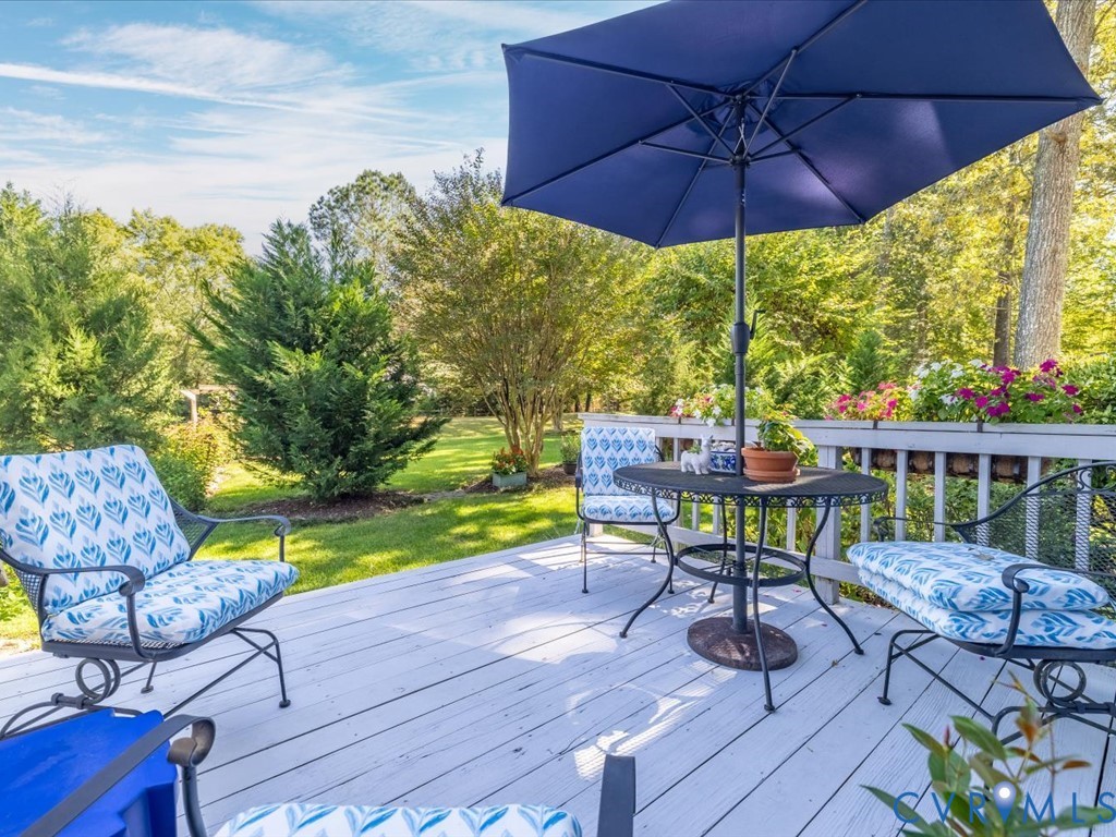 5309 Rock Harbour Road Midlothian, VA 23112 - Photo 14 of 47 a view of a patio with a table chairs and a umbrella